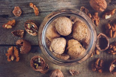Whole solid walnuts in a jar top view