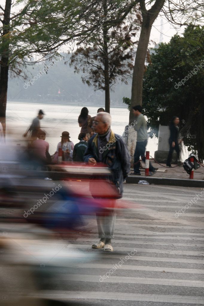 People Crossing Street In The Busy Streets Of Hanoi, Vietnam Stock