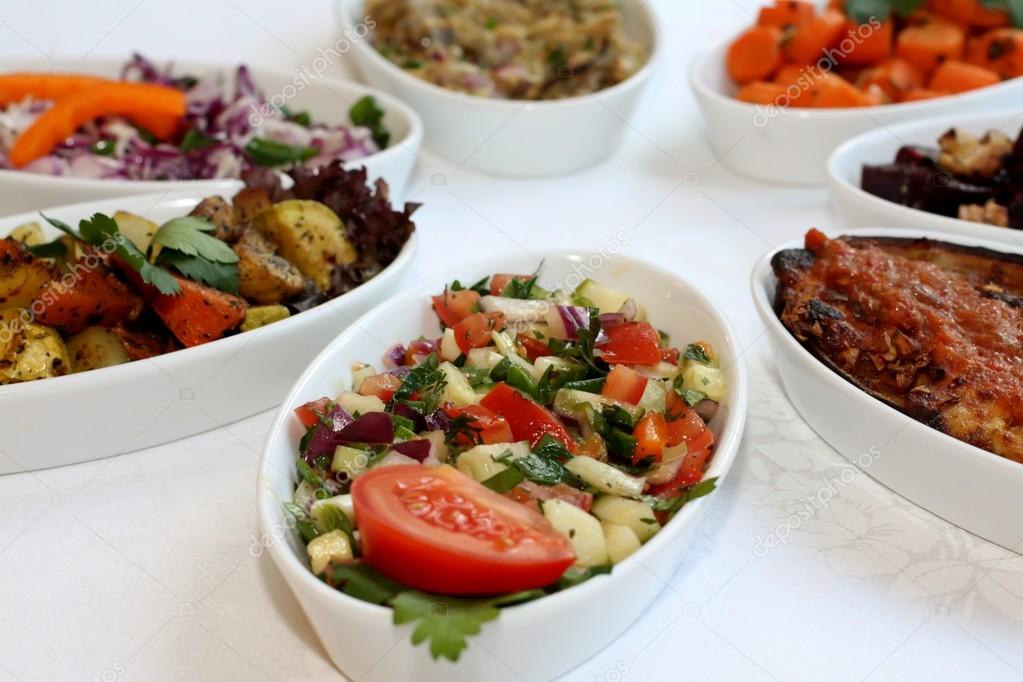 Closeup scene of different types of salads on restaurant table