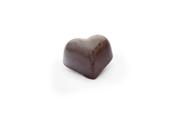 Black chocolate candy in the  shape of heart — Stock Photo, Image