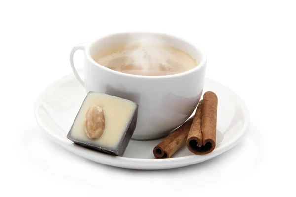 Cup of coffee with chocolate candy and cinnamons — Stock Photo, Image