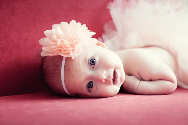 Smiling Newborn Baby Girl Flower Her Hair Red Sofa — Stock Photo, Image
