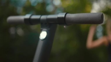Focus rack: From Electric scooter handle to a confident fit woman ready to start a ride with beautiful bokeh