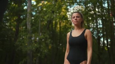 Focus rack: Fit woman turns around and grabs electric scooter handle bars with beautiful bokeh