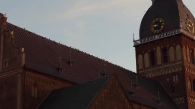 Evening view over birds sitting on top of Dome Cathedral - The main Riga Old Town tourist attraction real time