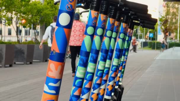 People Walking Many Colorful Electric Scooters Which Parked City Real — 图库视频影像