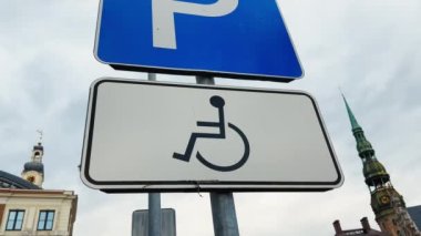 Old disabled sign on a pole at an old town in Europe real time