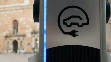 Close view: Modern electric car charger in an old european city real time