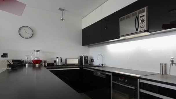 Moder black and white kitchen interior with red lamp