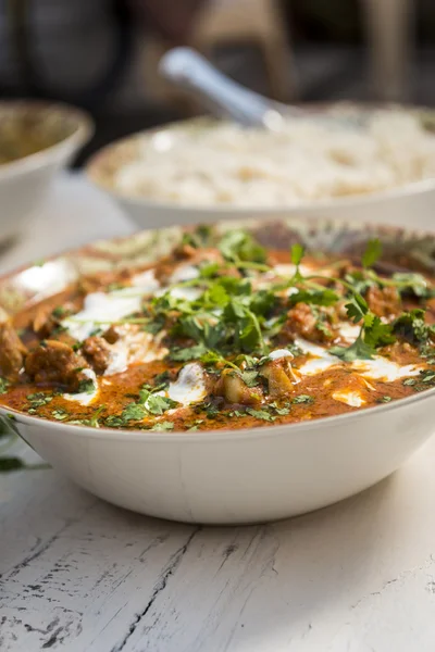 Tasty chicken butter masala on wooden table — Stock Photo, Image