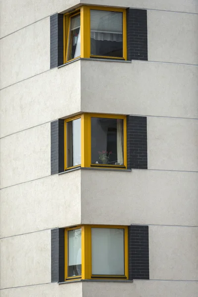 Yellow wooden windows in multi family house — Stock Photo, Image