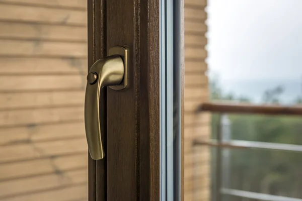 Window handle with wooden wall background — Stock Photo, Image