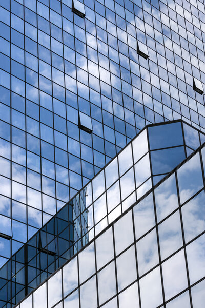 Perspective view to steel blue glass building skyscrapers