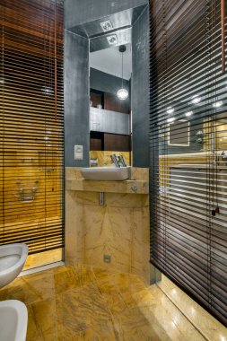 Stylish and expensive bathroom interior design with yellow marble finishing