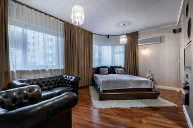 Stylish and expensive interior design bedroom with wooden floor