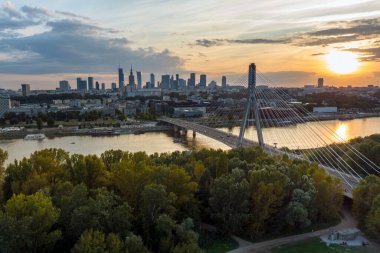 Panorama of Warsaw in Poland with Siekierkowski bridge over Vistula river during sundown.