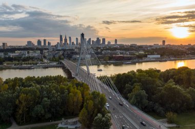 Panorama of Warsaw in Poland with Siekierkowski bridge over Vistula river during sundown.