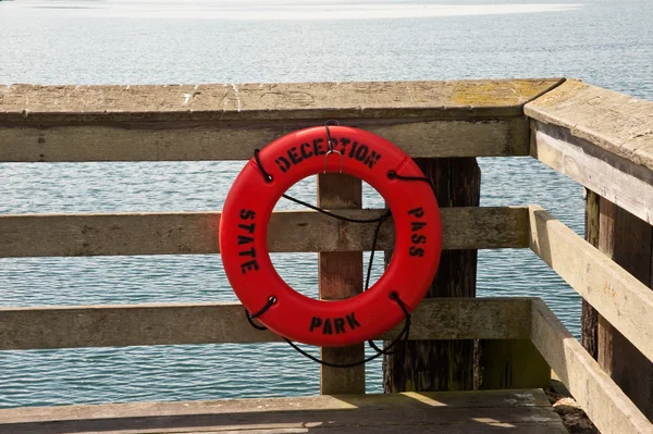 Pier and life ring — Stock Photo, Image