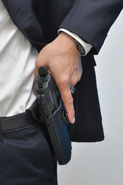 Agente vistiendo camisa blanca sacando pistola de la funda — Foto de Stock