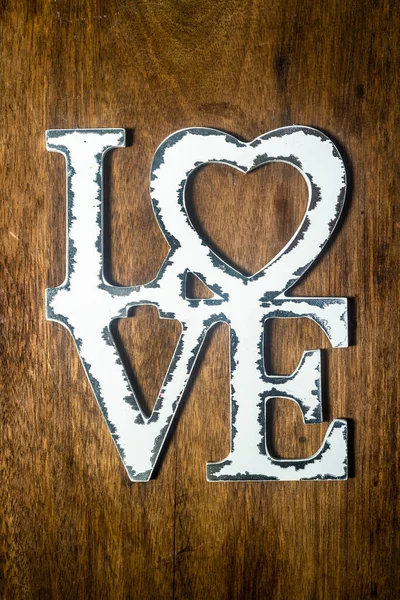 white love letters on wooden wall. The concept of happiness, peace, brotherhood, beautiful world