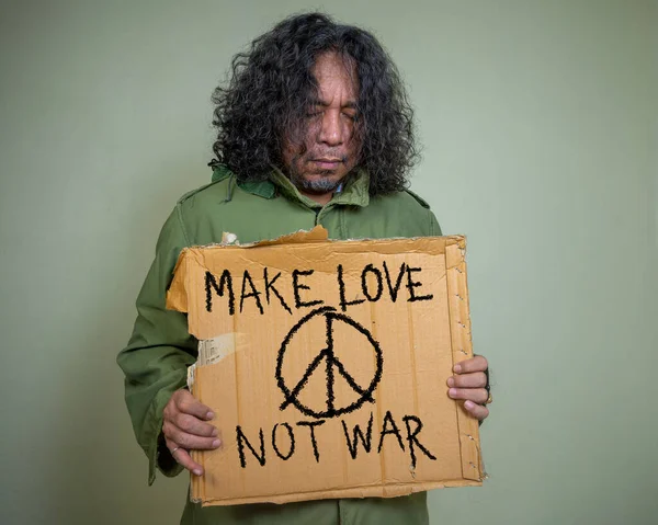 Man Serious Sad Holds Cardboard Poster Inscription Make Love War — 스톡 사진