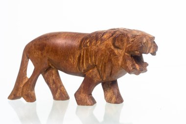 Wooden lion figurine on a white background. Home decoration. Close up