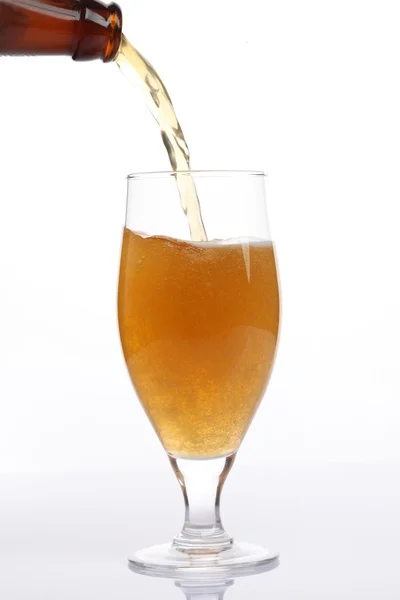 Beer is pouring into glass on white background — Stock Photo, Image