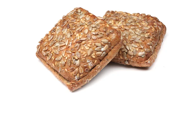 Bun of rye bread topped with sunflower seeds isolated over white background — Stock Photo, Image