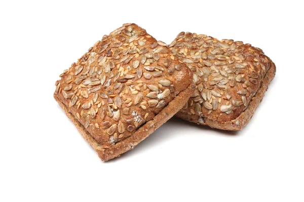 Panino di pane di segale condito con semi di girasole isolati su fondo bianco — Foto Stock