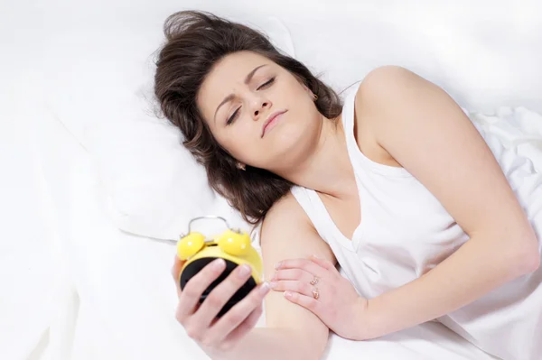 Woman with an alarm clock — Stock Photo, Image