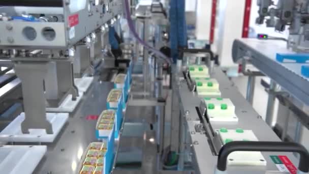 Automated plant, conveyor line. Modern plant. Machines work. Products in boxes. Robotic machine. — Stock Video