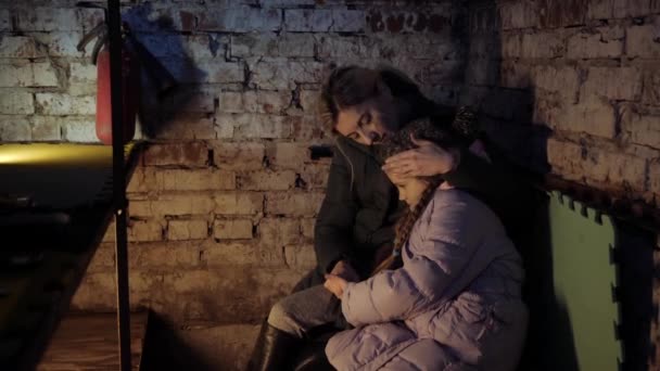 Refuge. Ukraine war. Shelter. Ukrainian mother and child in the basement. With fear suffering and praying peace during war conflict. Bunker, — Stock Video