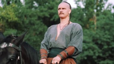 Zaporozhye Cossack on horseback. Ukrainian Cossack in the Zaporozhian Sich. Strong people. Patriots of their country.