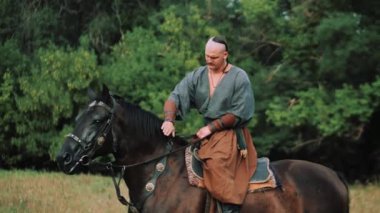 Zaporozhye Cossack on horseback. Ukrainian Cossack in the Zaporozhian Sich. Strong people. Patriots of their country.