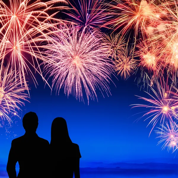 Couple enjoying a fireworks display