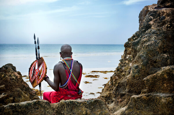 Maasai sitting by the ocean