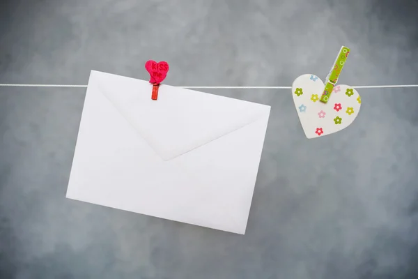 Letter and heart hanging on the clothesline — Stock Photo, Image