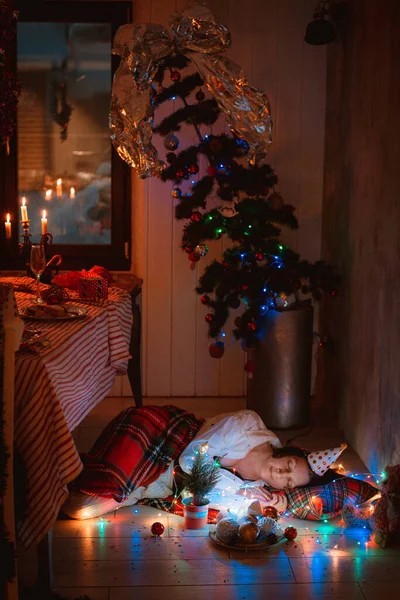 Pacificamente mulher dormindo coberto com cobertor sob a árvore de Natal descansando após a festa de Ano Novo — Fotografia de Stock
