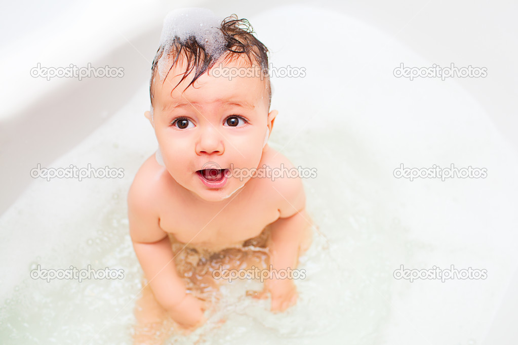 Little baby splashing in bath