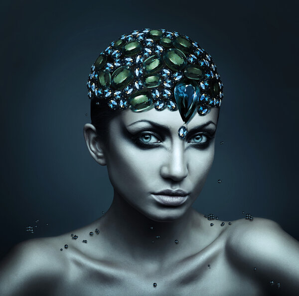Close up portrait of sexy brunette woman with hat of gemstones