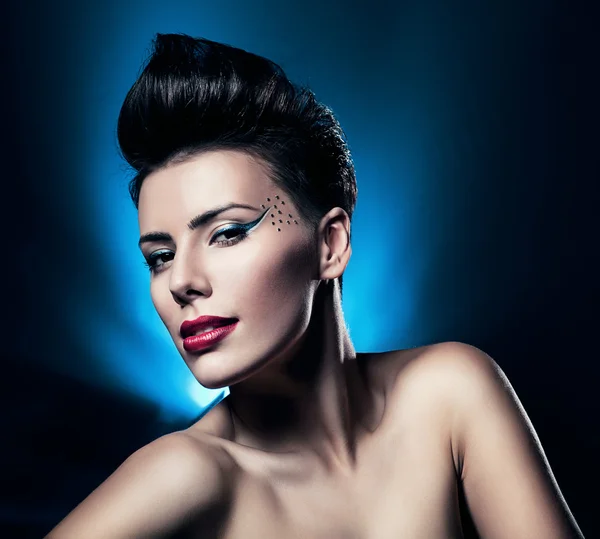 Sexy brunette woman with red lips in blue light — Stock Photo, Image