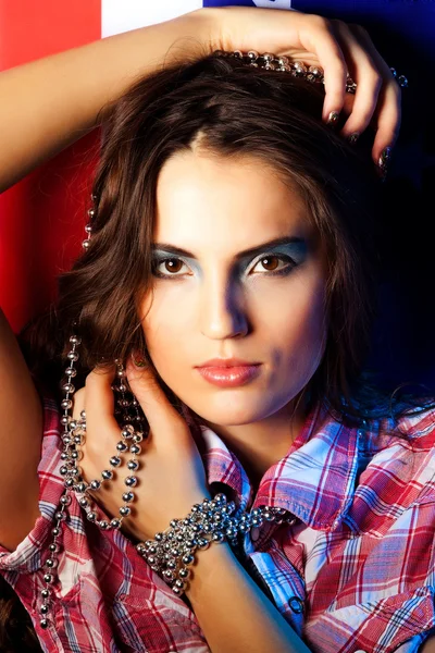 Pretty brunette woman wearing dress on dark background — Stock Photo, Image