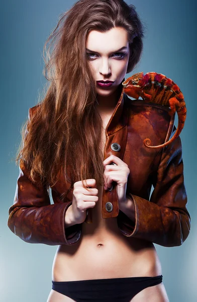 Pretty erotic devil woman in leather jacket with chameleon — Stock Photo, Image