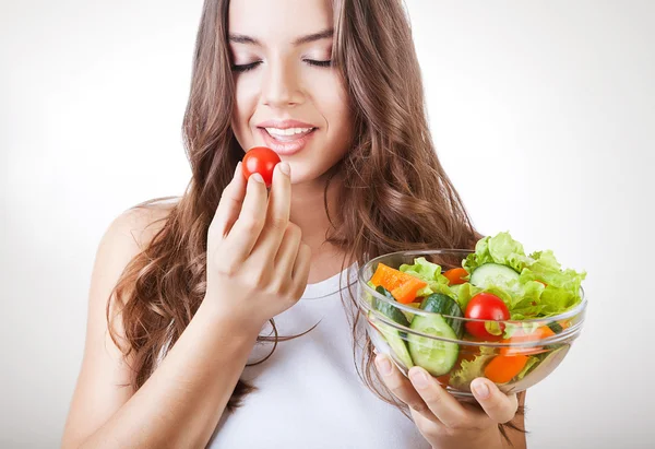 Woman eating salad with closed eyes — Stock Photo, Image