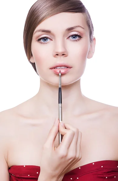 Cute woman with cosmetic brush on lips — Stock Photo, Image