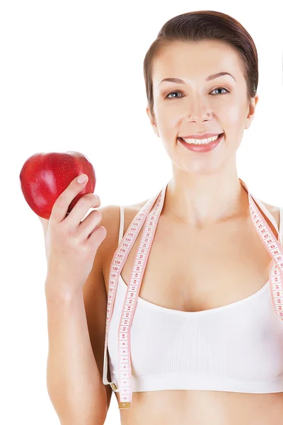 Happy sporty girl with red apple in hand — Zdjęcie stockowe