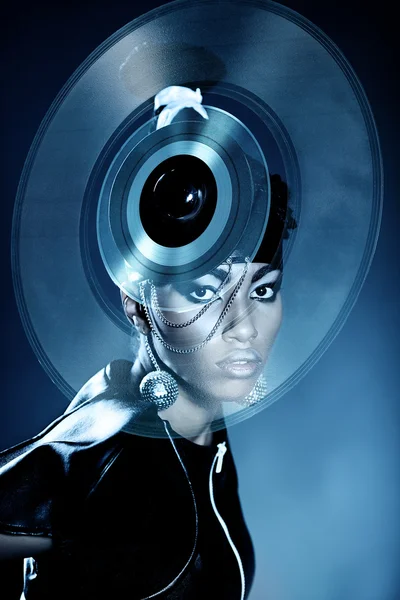 Attractive african woman with vinyl record on the head — Stock Photo, Image