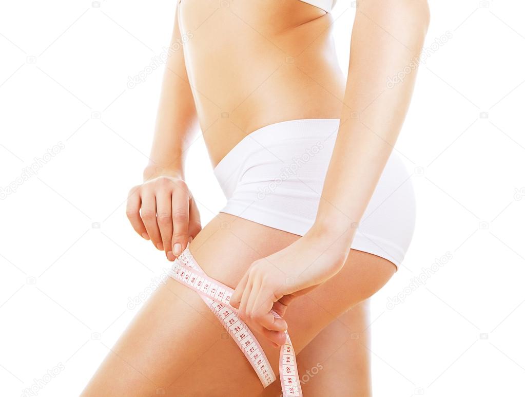 close-up photo of sporty woman shapes with measure