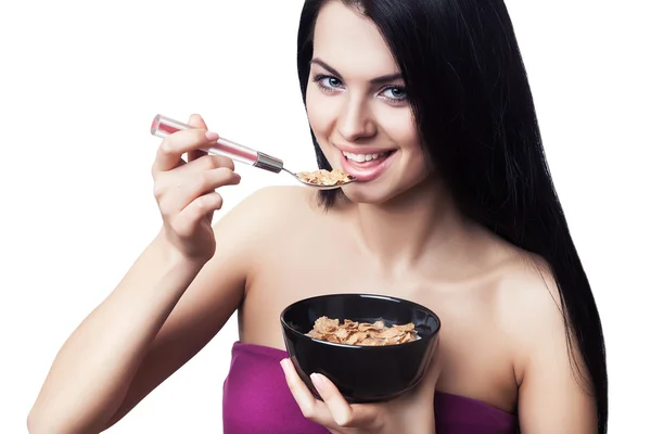 Smiling woman eating corn flakes — Stock Photo, Image