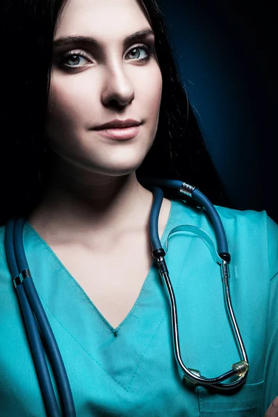 Doctor with stethoscope in dark — Stock Photo, Image